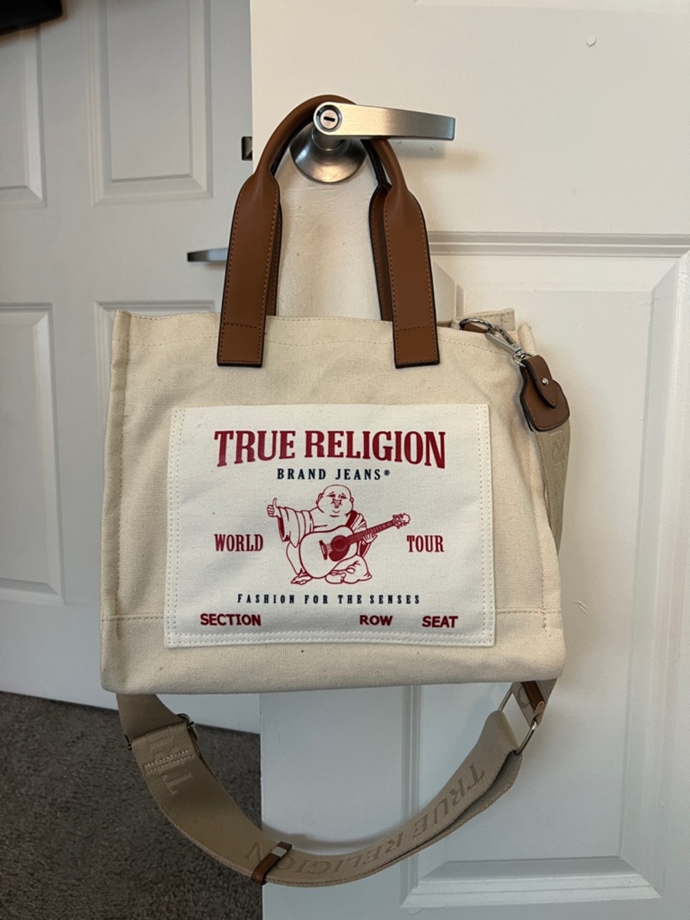 True Religion Cream Canvas Messenger Tote with Brown Handles and Red Logo +